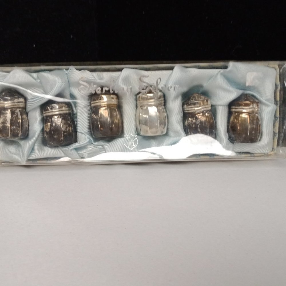 Vintage set mini sterling salt and pepper shakers.